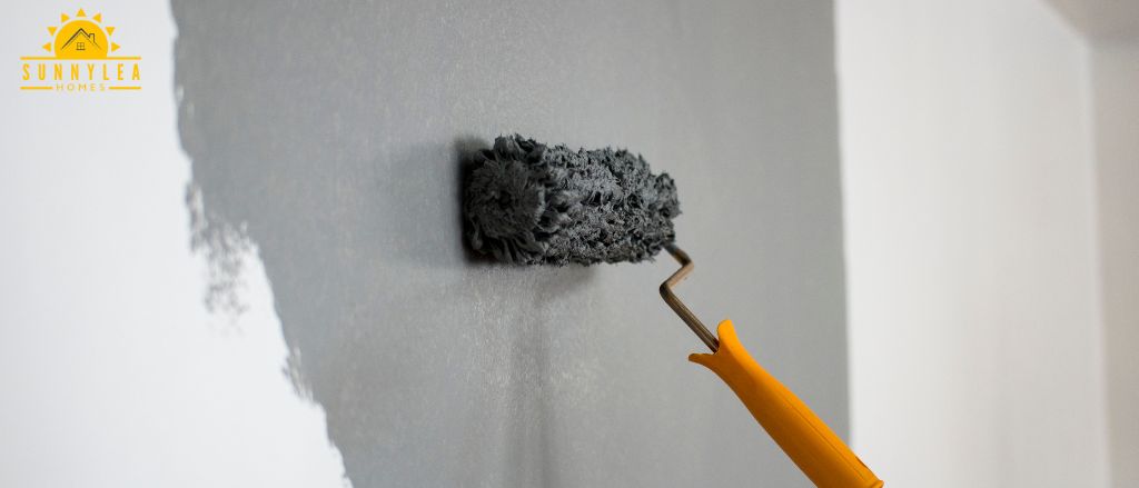 Colour Psychology into Interior Design - person painting a wall with a brush